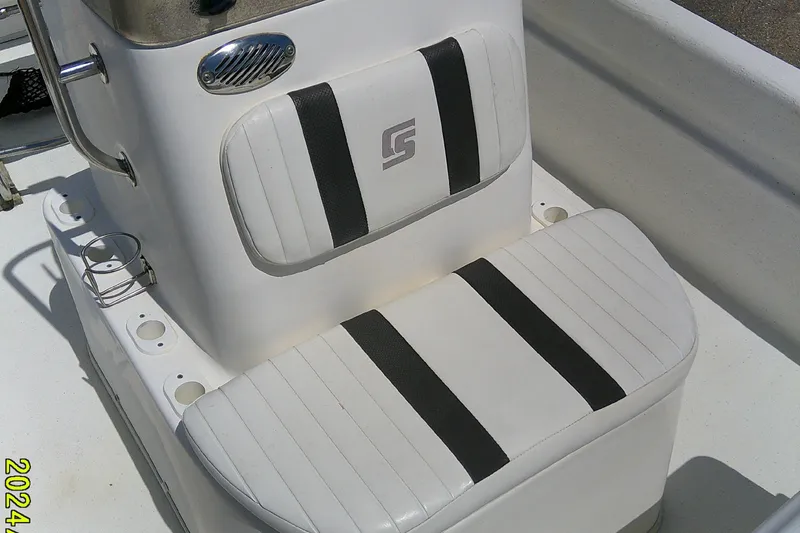 Slide: The Image of 2011 Carolina Skiff JVX18CC boat seat with white and black striped upholstery. - 11