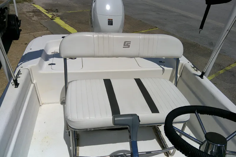 Slide: The Image of 2011 Carolina Skiff JVX18CC boat interior with white seating and steering wheel. - 12