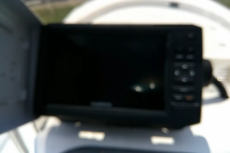 Slide: The Image of Blurry image of a 2011 Carolina Skiff JVX18CC dashboard with electronic display. - 14