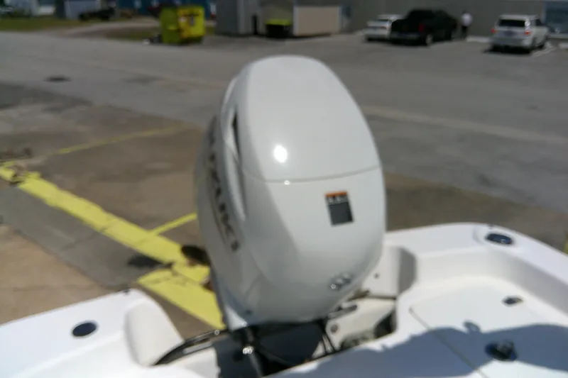 Slide: The Image of 2011 Carolina Skiff JVX18CC boat with outboard motor in a parking lot. - 16