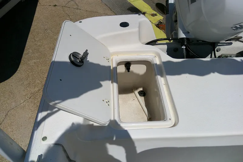 Slide: The Image of 2011 Carolina Skiff JVX18CC boat storage compartment with open hatch. - 17