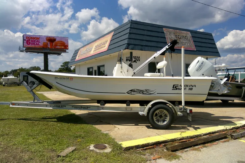 Slide: The Image of 2011 Carolina Skiff JVX18CC boat on trailer, parked outside a dealership. - 3