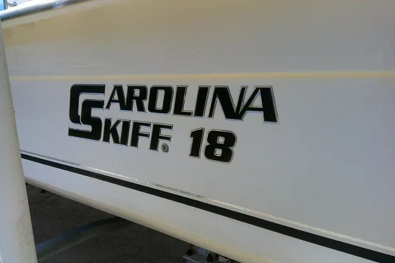 Slide: The Image of 2011 Carolina Skiff JVX18CC boat logo on white hull. - 4