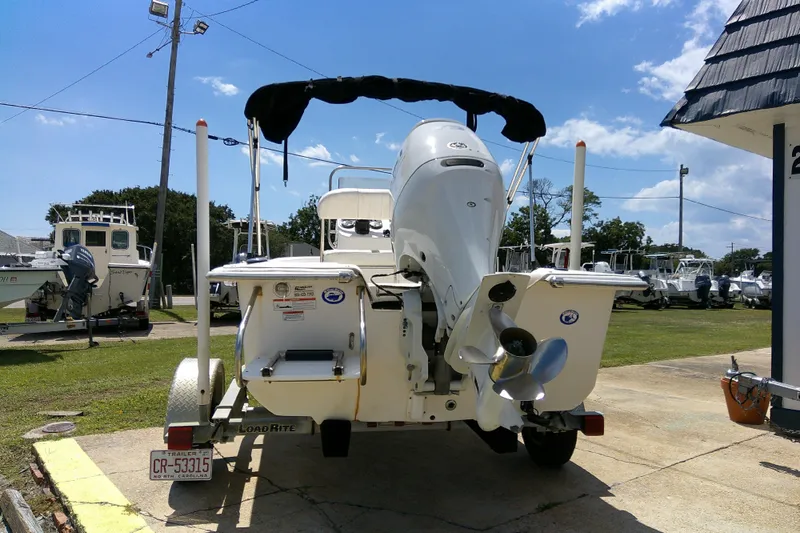 Slide: The Image of 2011 Carolina Skiff JVX18CC boat on trailer, outdoor display, sunny day. - 5