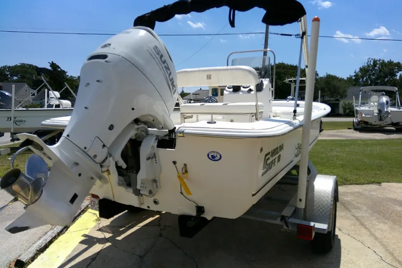 Slide: The Image of 2011 Carolina Skiff JVX18CC boat with Suzuki outboard motor on trailer. - 6