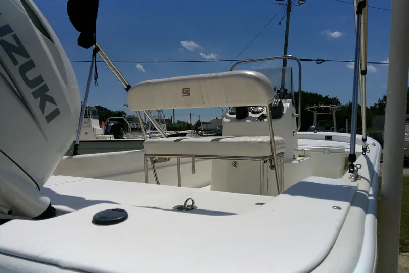 Slide: The Image of 2011 Carolina Skiff JVX18CC boat with Suzuki engine, white interior, and sunny outdoor setting. - 7
