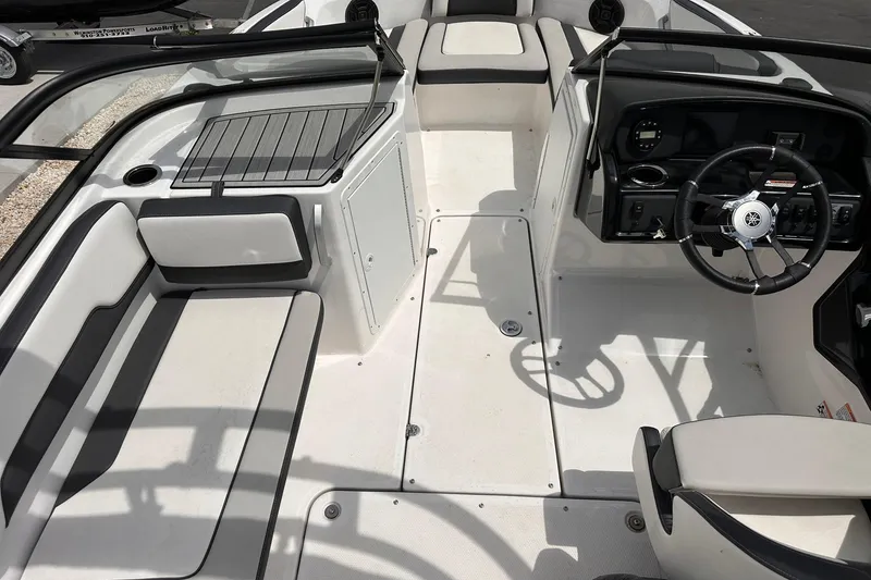 Slide: The Image of 2024 Yamaha Boats AR195 interior with sleek seating and modern dashboard design. - 10