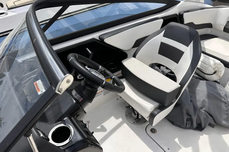 Slide: The Image of 2024 Yamaha Boats AR195 interior with steering wheel and captain's seat. - 13
