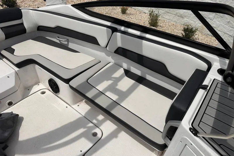 Slide: The Image of 2024 Yamaha Boats AR195 interior seating with sleek black and white design. - 14