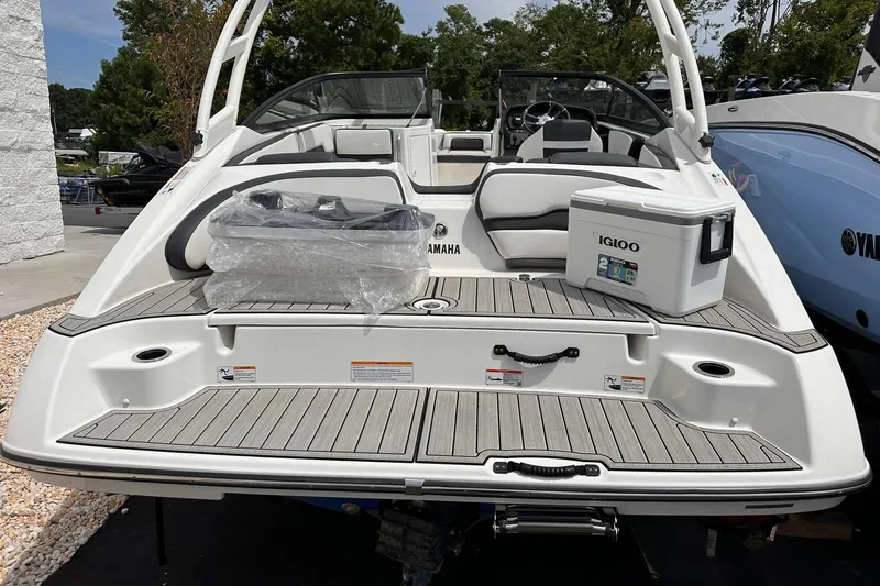 Slide: The Image of 2024 Yamaha Boats AR195 with Igloo cooler on deck, showcasing sleek design and spacious seating. - 6