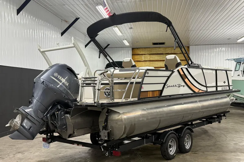 Slide: The Image of 2022 South Bay 523 UL pontoon boat with Yamaha outboard motor in a showroom. - 12