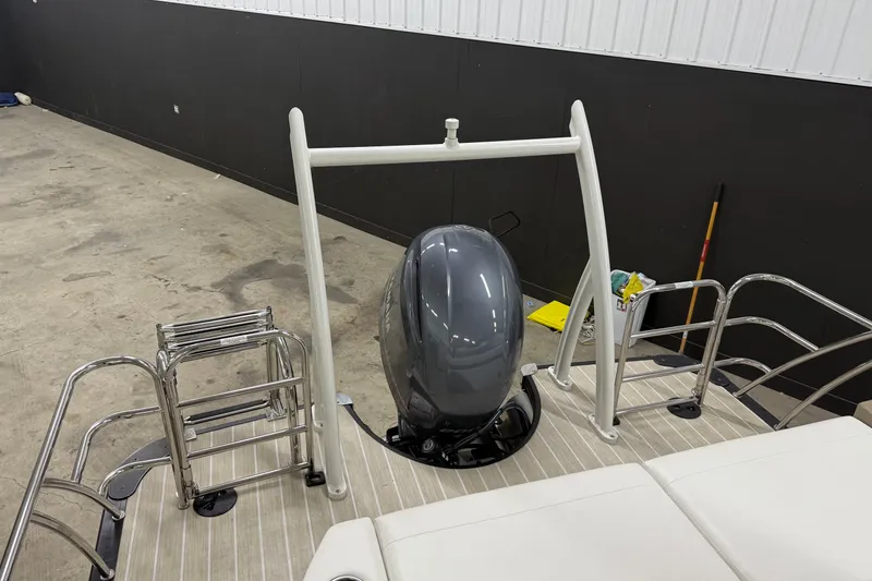 Slide: The Image of 2022 South Bay 523 UL boat with outboard motor and swim ladder in a garage. - 14