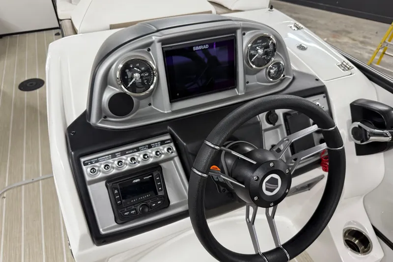 Slide: The Image of 2022 South Bay 523 UL boat dashboard with steering wheel and control panel. - 3