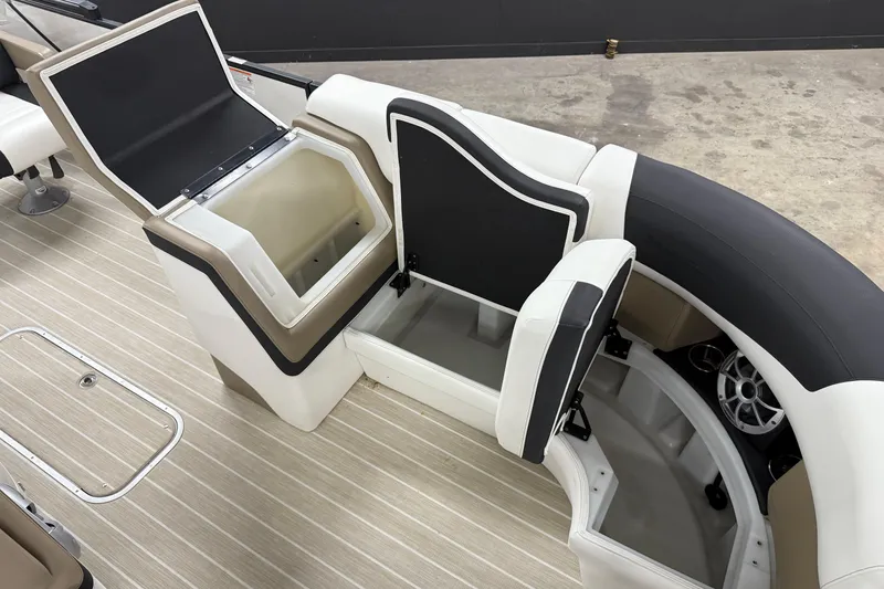 Slide: The Image of 2022 South Bay 523 UL boat interior with open storage compartments and seating. - 6