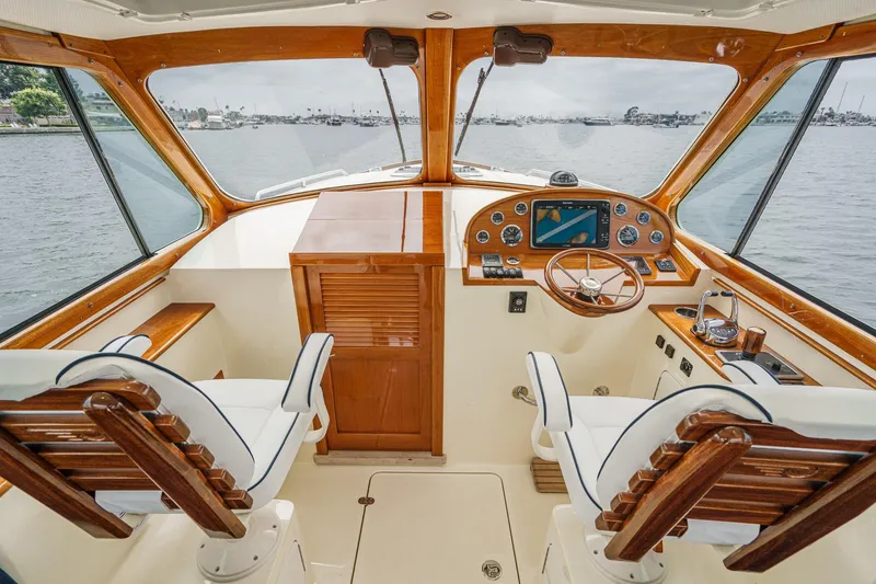 Slide: The Image of 2014 Hinckley Talaria 34 yacht cockpit with wooden helm and dual seating. - 17