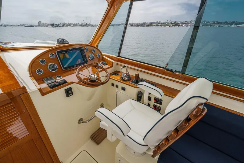 Slide: The Image of Helm of 2014 Hinckley Talaria 34 yacht with wooden dashboard and navigation equipment. - 18