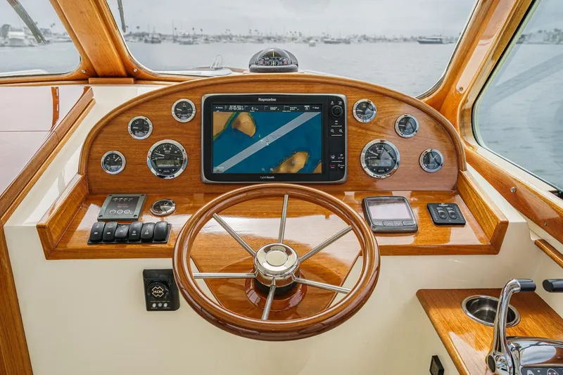 Slide: The Image of Helm of 2014 Hinckley Talaria 34 with navigation system and wooden steering wheel. - 21