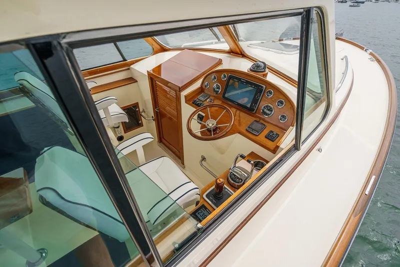 Slide: The Image of Interior view of 2014 Hinckley Talaria 34 yacht cockpit with wooden dashboard and steering wheel. - 22
