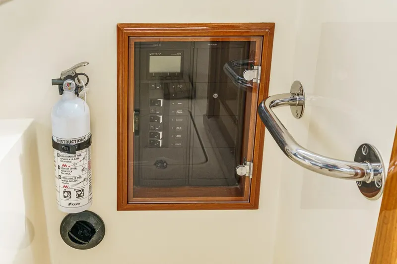 Slide: The Image of Hinckley Talaria 34 yacht interior, featuring control panel and fire extinguisher, 2014 model. - 24