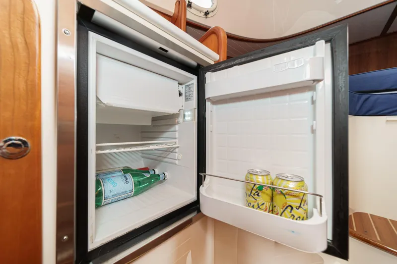 Slide: The Image of Open mini fridge on 2014 Hinckley Talaria 34 yacht, containing drinks and beverages. - 29