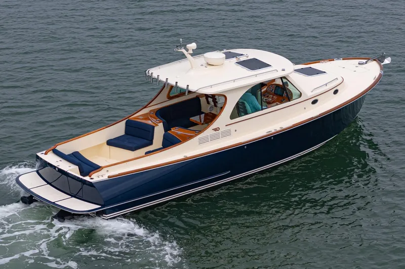 Slide: The Image of 2014 Hinckley Talaria 34 yacht cruising on open water, showcasing elegant design and luxury features. - 3