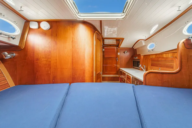 Slide: The Image of Luxurious 2014 Hinckley Talaria 34 yacht interior with wood paneling and blue upholstery. - 33