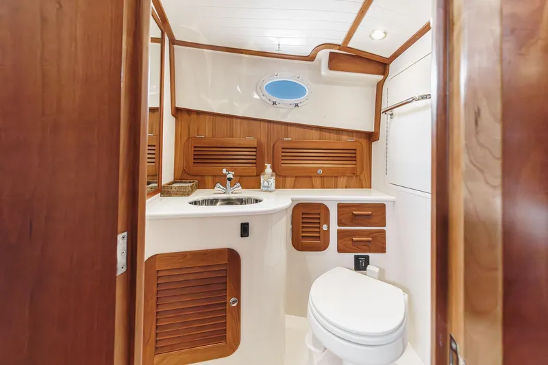 Slide: The Image of Luxurious 2014 Hinckley Talaria 34 yacht bathroom with wood accents and modern fixtures. - 34