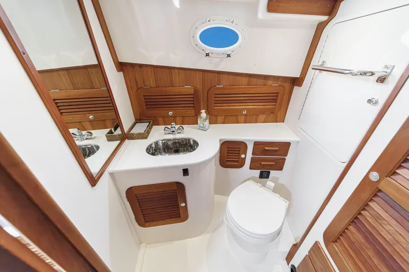 Slide: The Image of Luxurious 2014 Hinckley Talaria 34 yacht bathroom with wood accents and modern fixtures. - 35