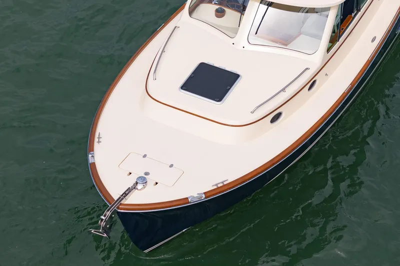 Slide: The Image of 2014 Hinckley Talaria 34 yacht on water, showcasing elegant design and craftsmanship. - 41