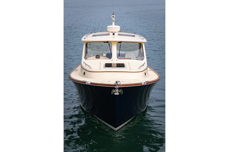 Slide: The Image of 2014 Hinckley Talaria 34 boat on calm water, front view. - 42