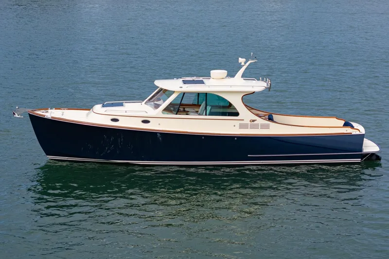 Slide: The Image of 2014 Hinckley Talaria 34 yacht on calm water, showcasing elegant design and craftsmanship. - 46