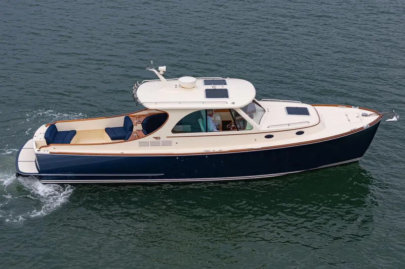 Slide: The Image of 2014 Hinckley Talaria 34 cruising on open water, showcasing elegant design and craftsmanship. - 5