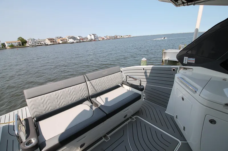 Slide: The Image of 2022 Galeon 325 GTO boat interior with seating, overlooking waterfront homes. - 13