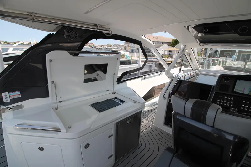 Slide: The Image of Interior of 2022 Galeon 325 GTO yacht with modern helm and seating area. - 16