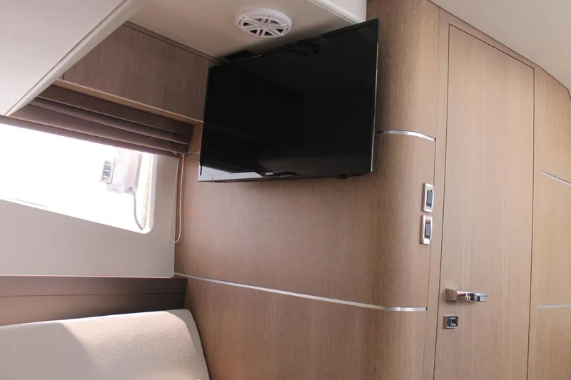 Slide: The Image of Interior of 2022 Galeon 325 GTO yacht with TV and modern wood paneling. - 30