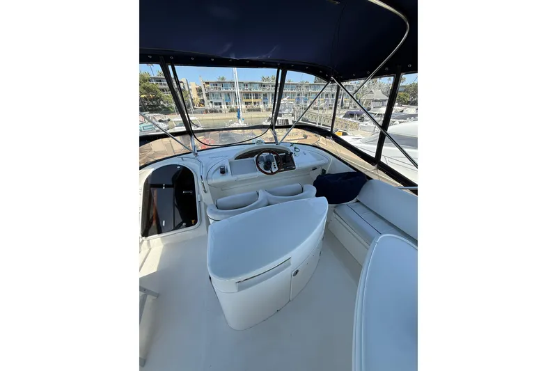Slide: The Image of Interior view of 2001 Fairline 55 yacht cockpit with seating and helm. - 11