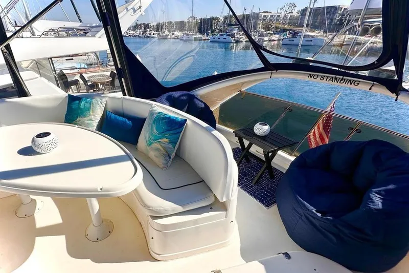 Slide: The Image of Luxurious 2001 Fairline 55 yacht interior with elegant seating and marina view. - 12
