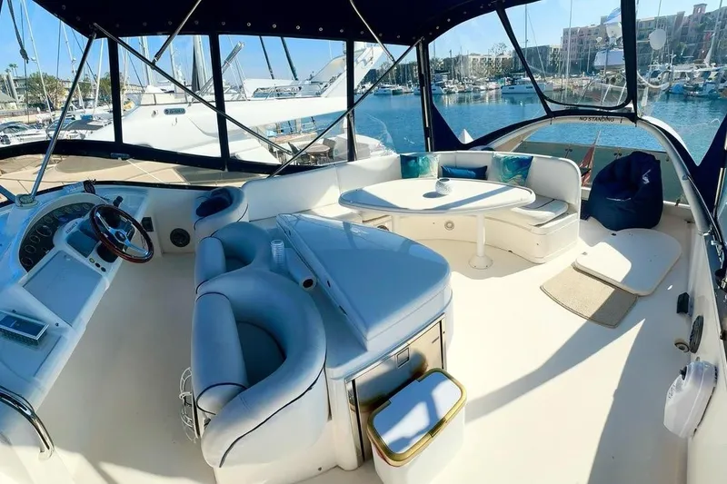 Slide: The Image of Luxurious 2001 Fairline 55 yacht interior with elegant seating and marina view. - 14