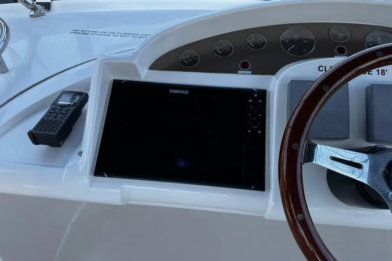 Slide: The Image of Control panel of a 2001 Fairline 55 yacht with Simrad display and steering wheel. - 16