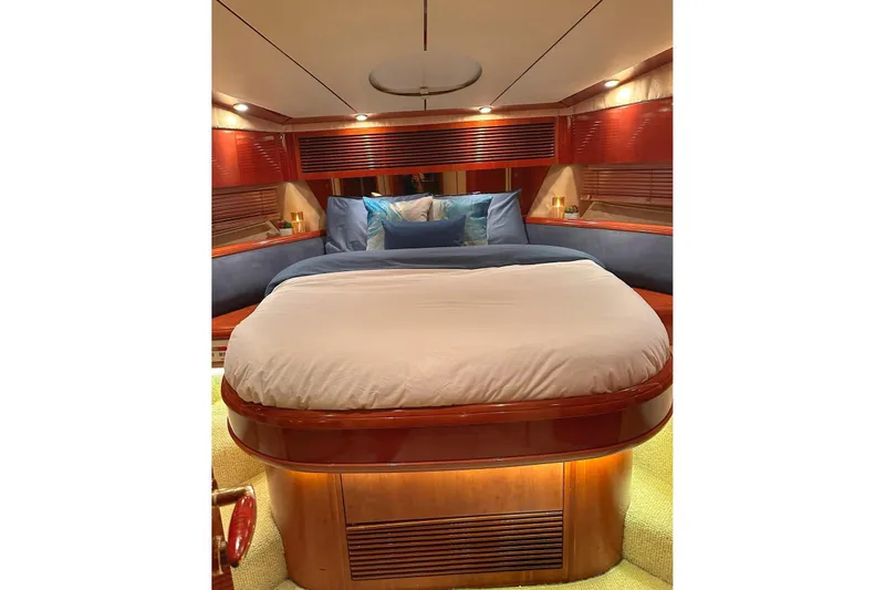 Slide: The Image of Luxurious cabin interior of a 2001 Fairline 55 yacht with elegant bedding and wood finishes. - 21