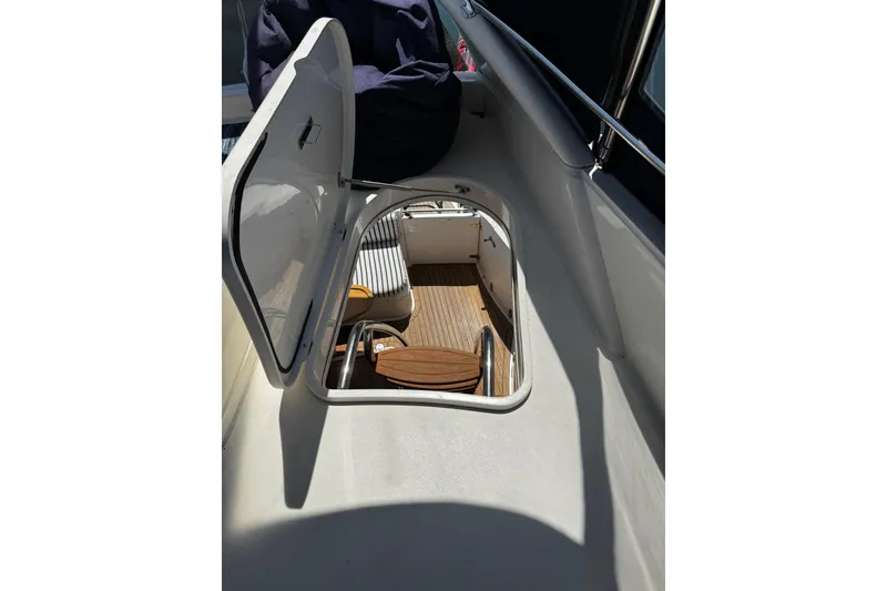 Slide: The Image of Open hatch on 2001 Fairline 55 yacht, revealing wooden interior and seating area. - 25