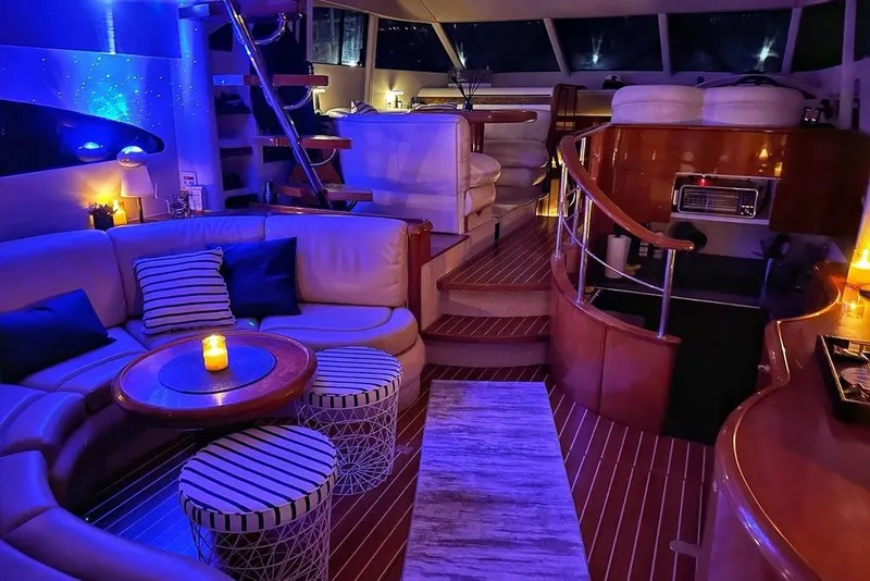 Slide: The Image of Luxurious interior of a 2001 Fairline 55 yacht with ambient lighting and elegant seating. - 27