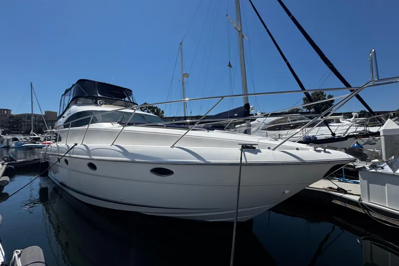 Slide: The Image of 2001 Fairline 55 yacht docked in marina under clear blue sky. - 3