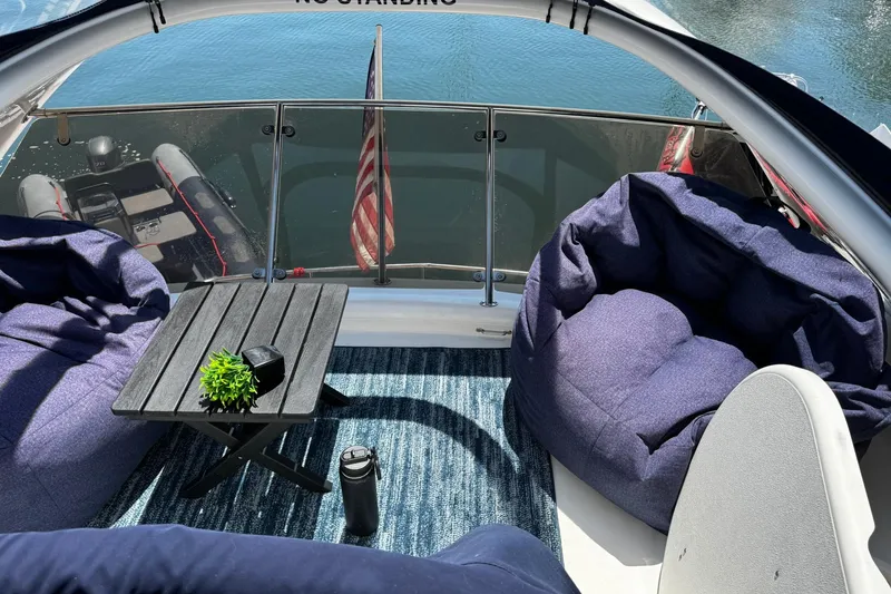 Slide: The Image of Luxurious 2001 Fairline 55 yacht deck with bean bags, table, and water view. - 32