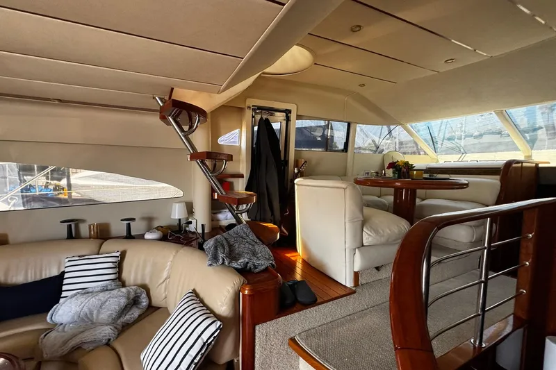 Slide: The Image of Luxurious interior of a 2001 Fairline 55 yacht with elegant seating and wooden accents. - 35