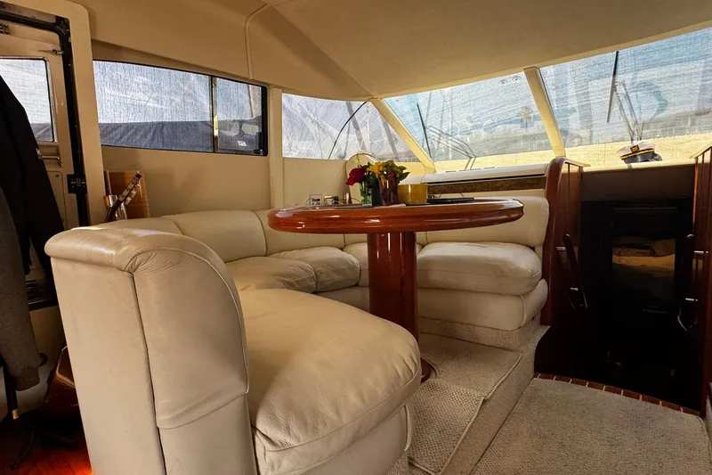 Slide: The Image of Luxurious interior of 2001 Fairline 55 yacht with plush seating and wooden table. - 38