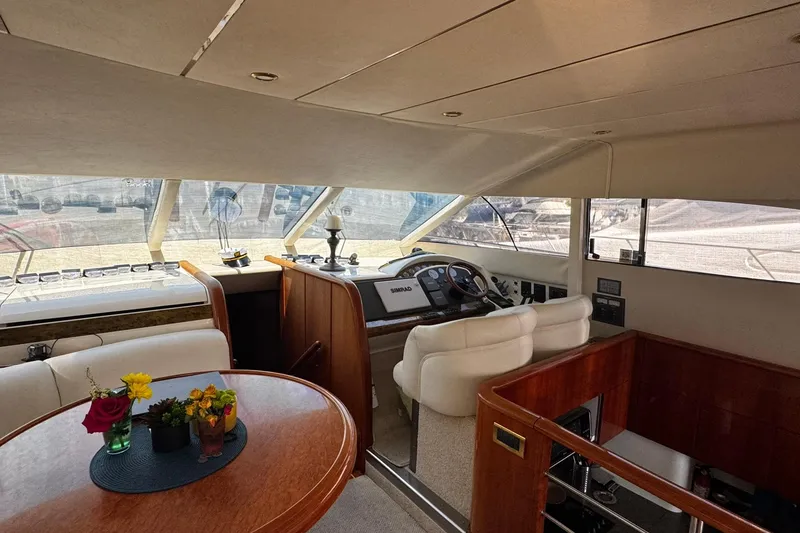Slide: The Image of Interior of 2001 Fairline 55 yacht with helm, seating, and floral centerpiece. - 40
