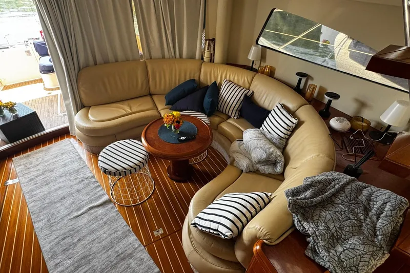 Slide: The Image of Luxurious interior of 2001 Fairline 55 yacht with leather seating and striped cushions. - 43