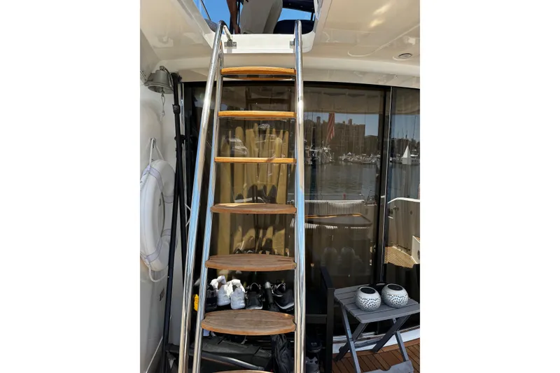Slide: The Image of Staircase on 2001 Fairline 55 yacht with marina view through glass doors. - 45