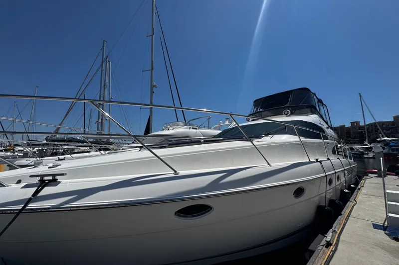 Slide: The Image of 2001 Fairline 55 yacht docked at marina under clear blue sky. - 6